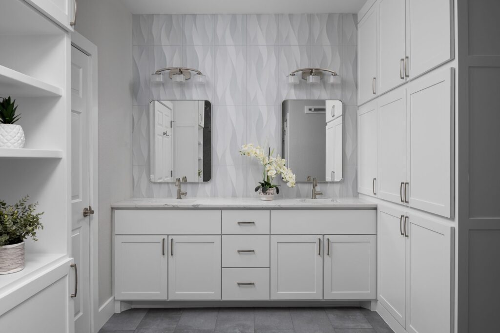 White shaker double vanity with tall storage towers in a bathroom remodel