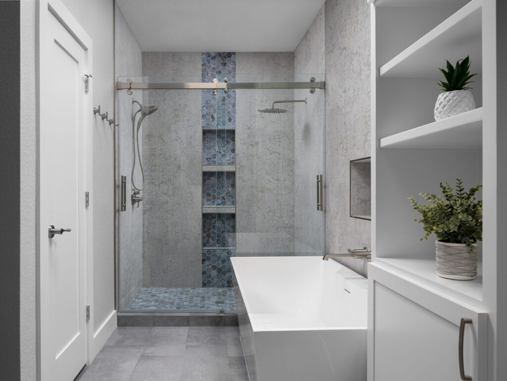 Walk-in shower with blue mosaic stripe beside a freestanding tub
