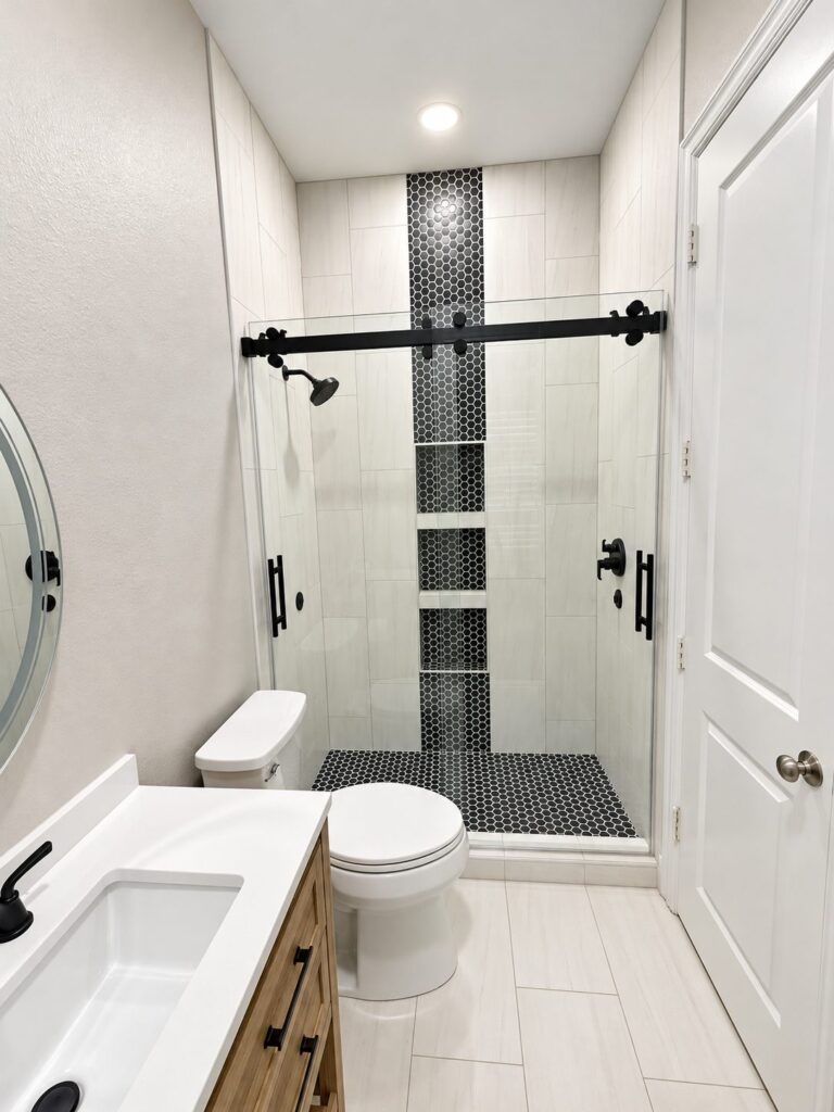 Keller bath remodel with black hexagon shower accent and sliding glass door