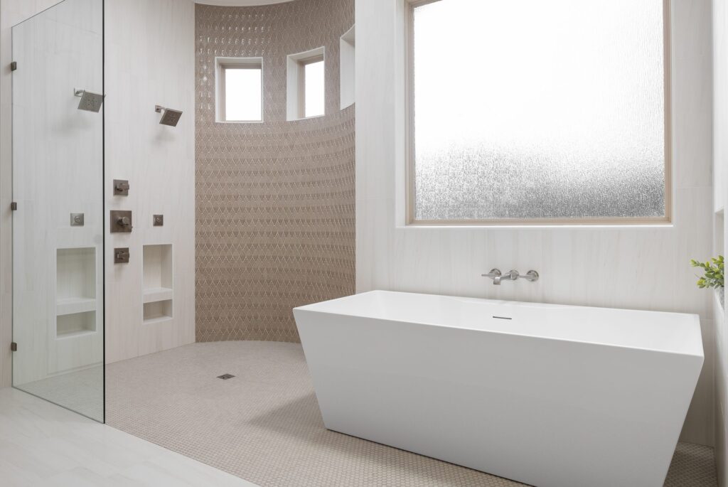 Curbless wet room with freestanding tub, body sprays and frosted window in Argyle, Texas
