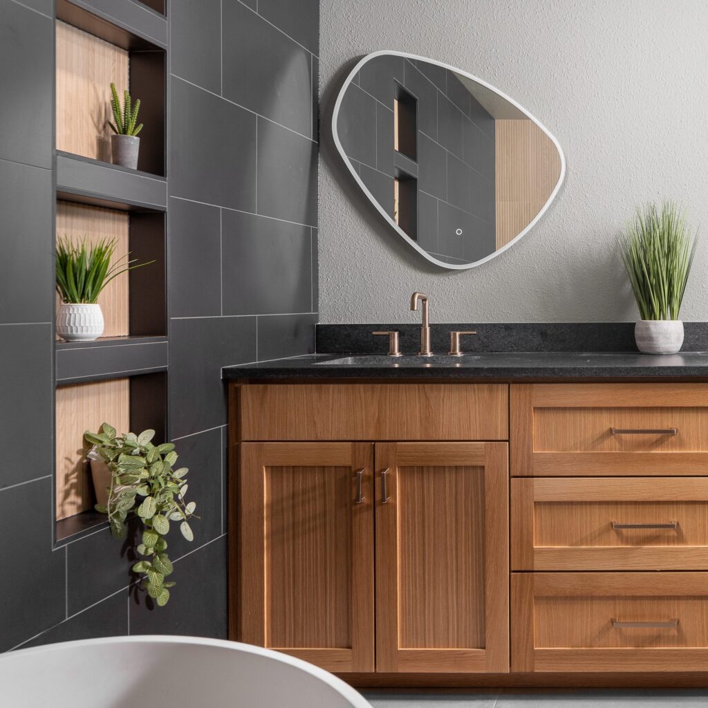Wood shaker vanity with charcoal countertop and built-in display shelving