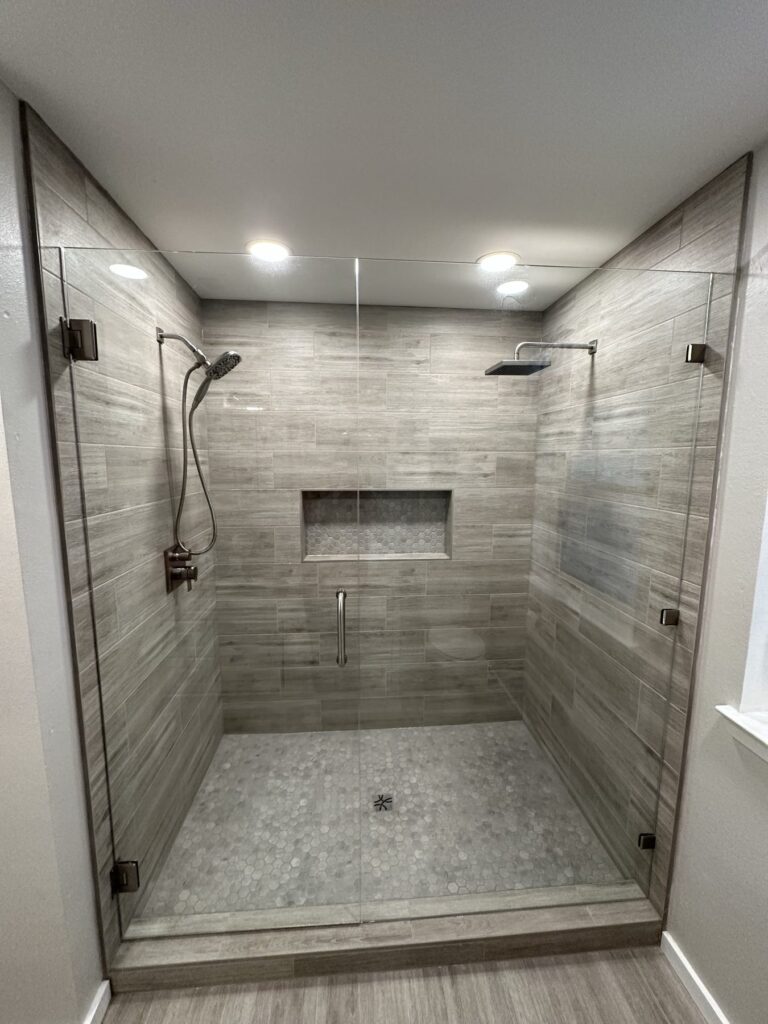 Walk-in shower remodel with frameless glass and dual shower heads