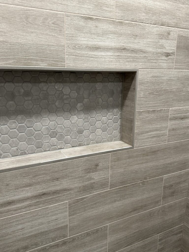 Shower niche with hexagon tile inlay