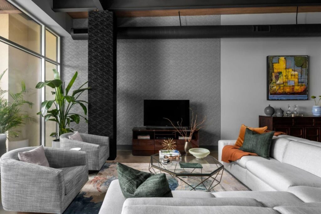 Living room seating area with geometric coffee table in a whole-home condo remodel