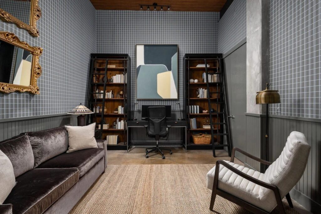 Study with velvet sofa, gold mirrors and plaid wallcovering in a remodeled condo